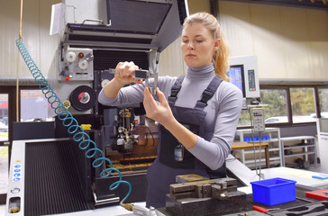 A young woman works as a computerized  numerical control technician. She is seen at her workplace...
