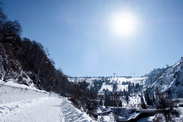Fototapeta na wymiar Medeo or Medeu dam in winter sunny day. Winter landscape.