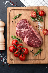 ribeye steak on a wooden board. raw meat, beef. View from above