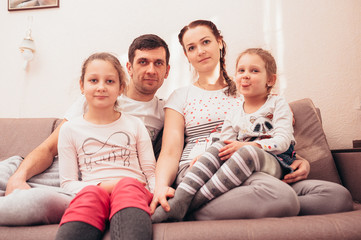 Happy family at home on the couch