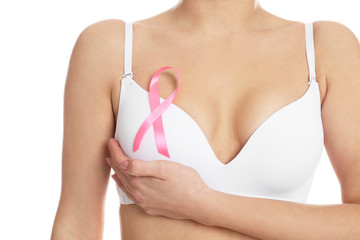 Woman with pink ribbon on white background, closeup. Breast cancer awareness