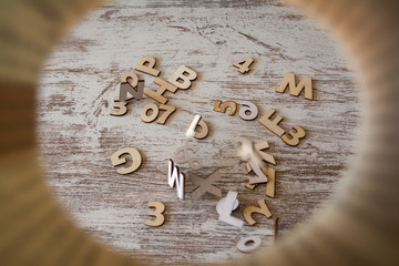 Wooden letters and numbers falling from above.
