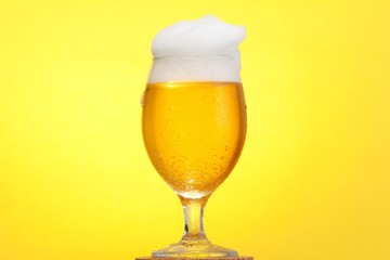 Golden cold beer glass foam, yellow.Golden cold beer glass foam, yellow.