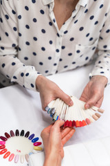 Professional master demonstrating samples of nail polish
