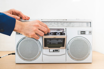 Image of Man Playing an Old Radio Indoors. Close Up of Vintage Radio