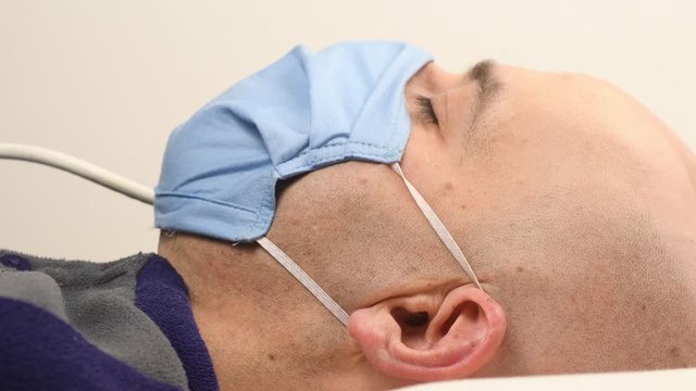 man in hospital with mask and intubation