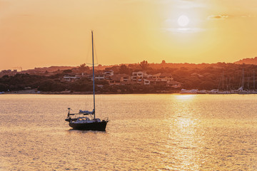 Sunrise with boat at Mediterranean sea Sardinia