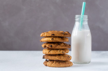 Gluten free oat cookies and oat milk in glass bottle on bacground.Selective focus,close up.