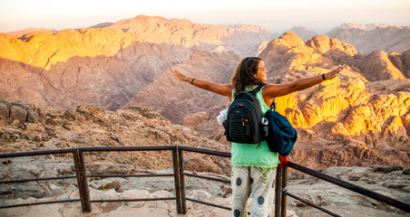 Woman feeling good on mountain trek adventure watching sunrise, SInai, Egypt, Africa