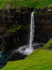 Faroe Islands. Múlafossur Waterfall. Vertical. Long exposure.