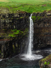 Faroe Islands. Múlafossur Waterfall. Vertical. Long exposure.