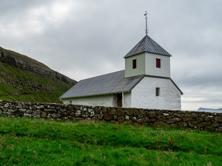 Faroe Islands. Kirkjubøur. Old and white church.