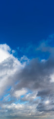 Fantastic clouds against blue sky, panorama