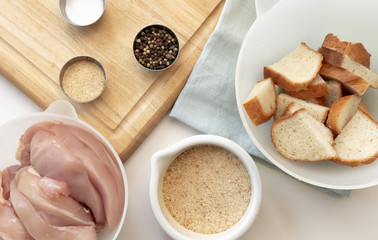 Cooking homemade cutlets. Ingredients: chicken meat, spices, breadcrumbs, white bread. Concept of healthy home-made food, flat lay
