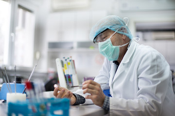 Biologist working with sample in petri dish in laboratory