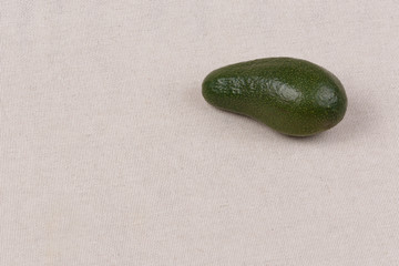 whole avocado on fabric background