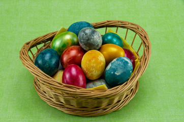 Easter, colored painted eggs in a wicker basket