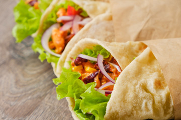 Mexican burrito with chicken, pepper and beans close up