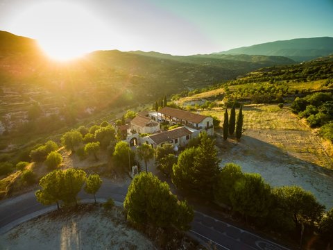 Aerial bird's eye view of Holy monastery of Archangel Michael (Archangelou Michail) in Monagri village, Limassol, Cyprus, an ancient christian religious monument, at sunset flare, from above.