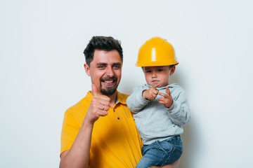 Little boy on his hands in a construction helmet