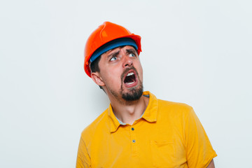 man close-up in helmet , holding his head by hand