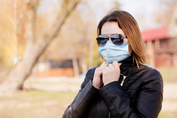 woman in a protective mask and sunglasses