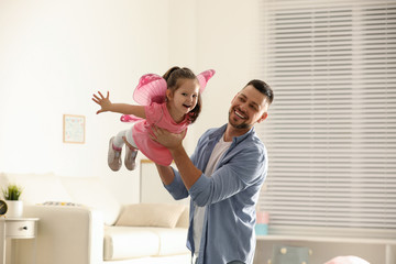 Father playing with his child at home