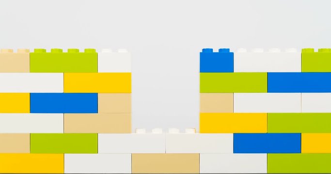 Colorful bricks making wall on white background