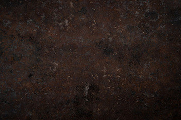 Texture of dark old rusty metal with traces of corrosion and burning