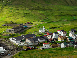 Fototapeta na wymiar Faroe Islands, Eysturoy, Gjogv. View over the town from slopes of mountains surrounding the Gjogv. Panoramic view of this idyllic village.