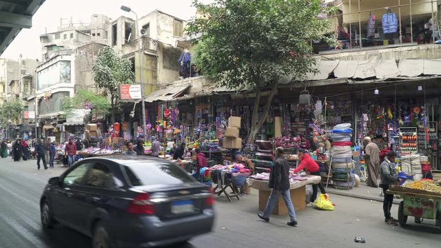 Open street market and car traffic in central Cairo, Egypt. Panning video.