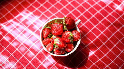 Group of strawberry in a white bowl, Strawberry in red background,