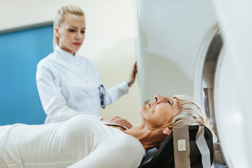 Mature female patent during CT scan examination in the hospital.