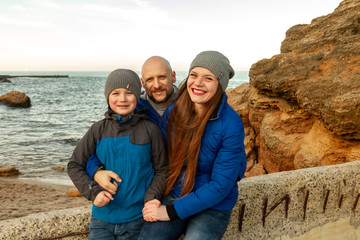 family walk on the sea coast in spring