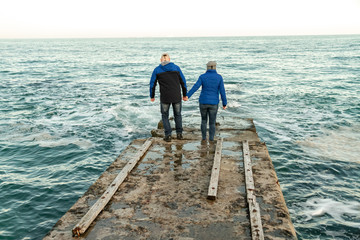 couple walking on pier
