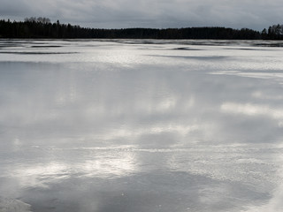 Calm surface of wet melting ice cover