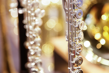 A closeup view of a silver flute instrument, on display at a local music store. © DAVID