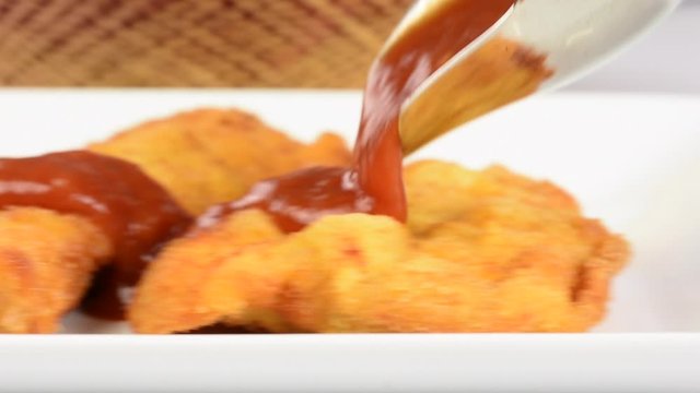 Pouring tomato sauce in milanese file