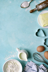 Culinary background with ingredients for baking : flour, butter, eggs, milk and sugar. Top view with copy space.
