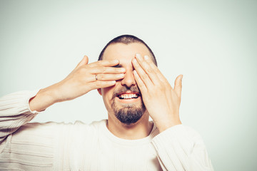 Man closes eyes with her hands