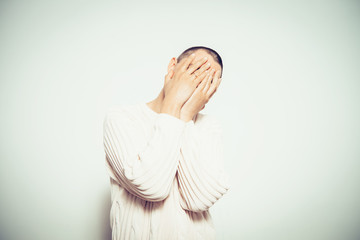 Man covering his face