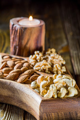 Fototapeta na wymiar walnuts, cashews, almonds, dates, raisins on wooden table