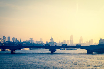 Scenic misty view of the London city skyline over the River Thames and Waterloo Bridge