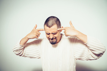 Closeup portrait of angry man gesturing with his finger against his temple, are you crazy?