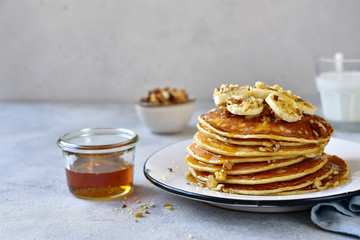 Homemade delicious banana pancakes with walnuts and maple syrup.