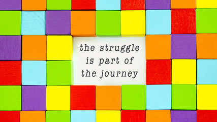 The Struggle is Part of the Journey typed on white paper in a conceptual image of inspiration and motivation.