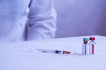 Coronavirus vaccine, the concept of a coronavirus vaccine with a syringe and a medicine bottle. The concept of vaccine against coronavirus. Vaccination.