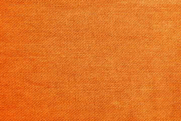Texture of orange jeans as background, closeup