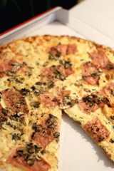 Pizza with cheese, ham and portobello mushrooms in a box. Selective focus.