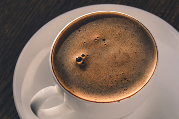 Coffee white cup with foam. Overhead view